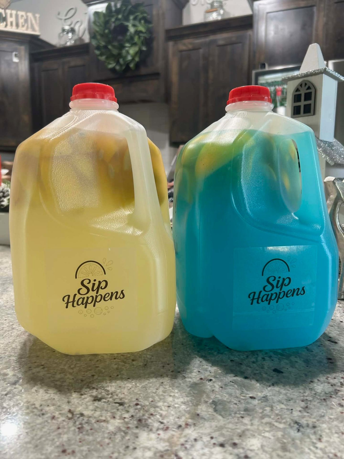 Two Sip Happens gallon jugs — classic lemonade and blue raspberry